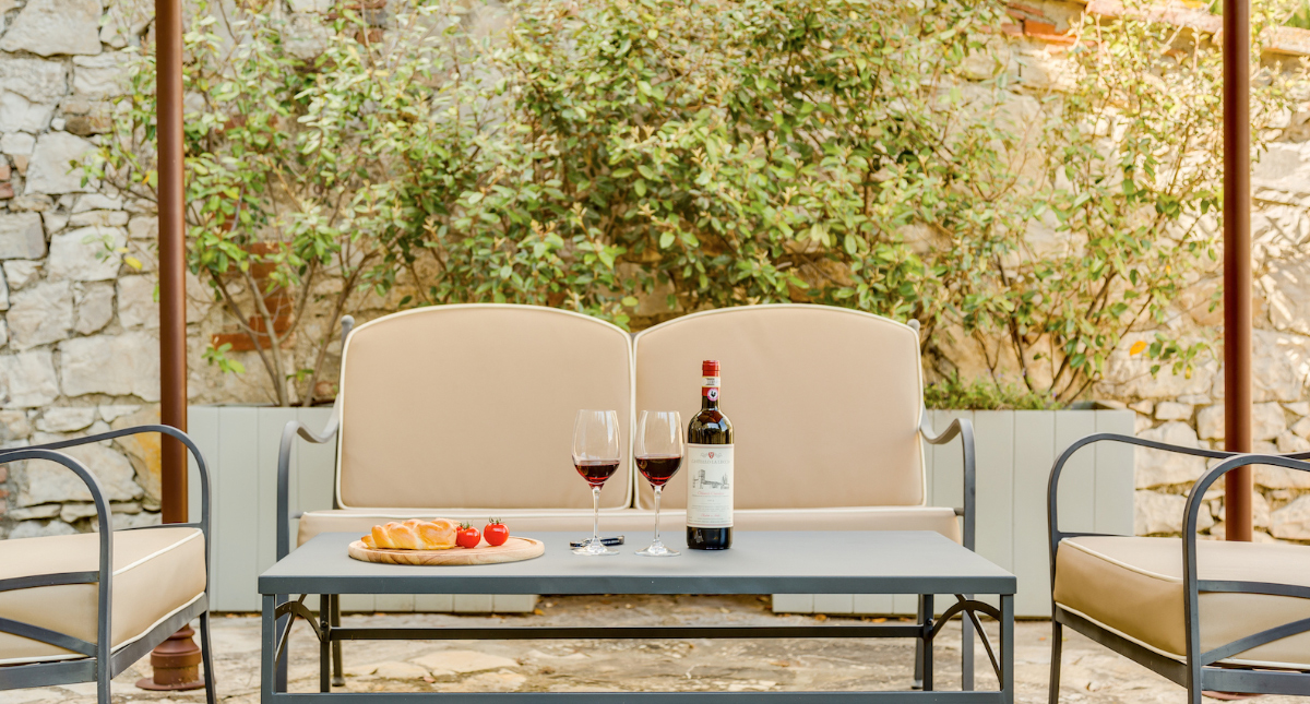 Castello La Leccia patio seating with wine and cheese