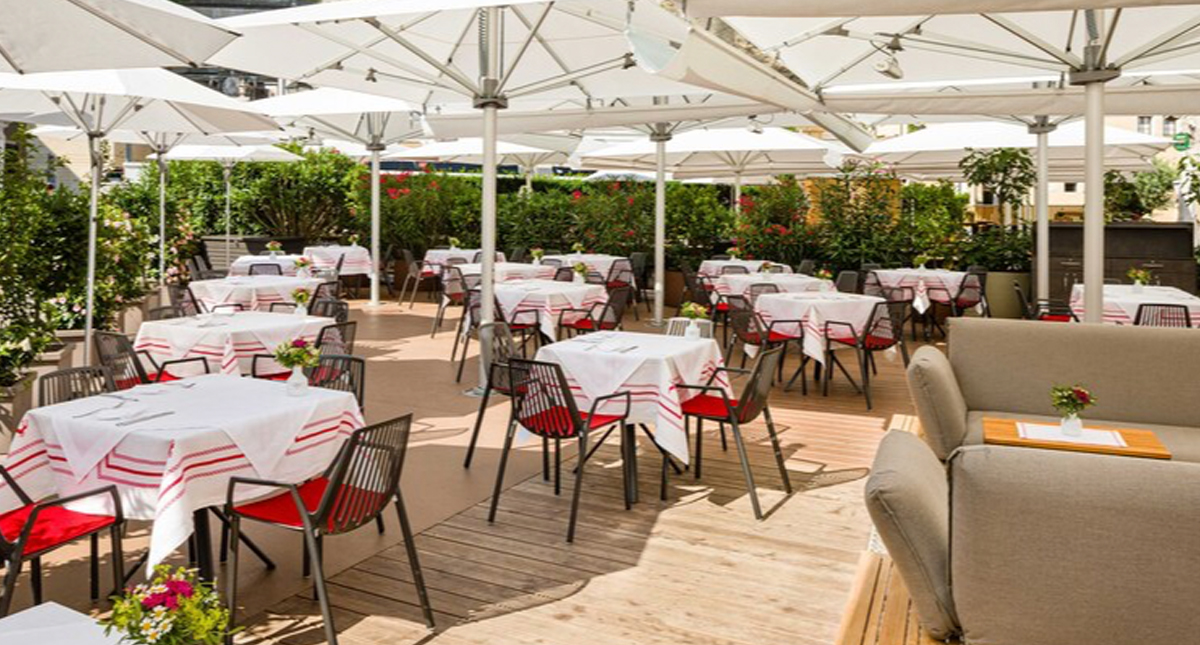 Hotel Goldener Hirsch outdoor patio dining under umbrellas