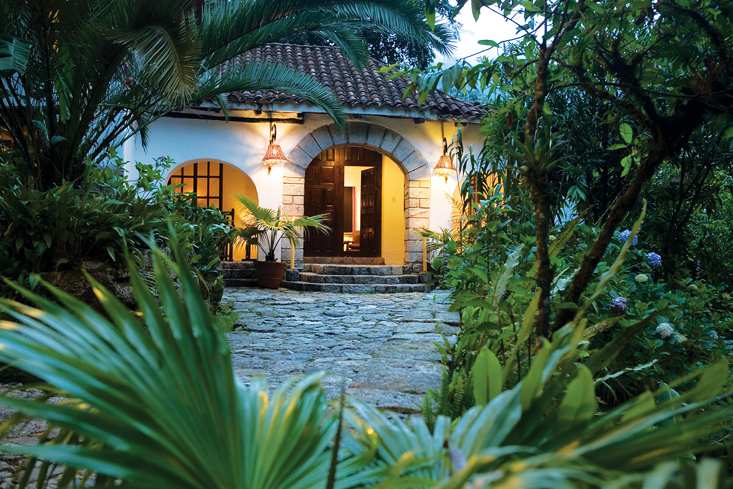 Inkaterra Machu Picchu Pueblo Hotel exterior illuminated at night