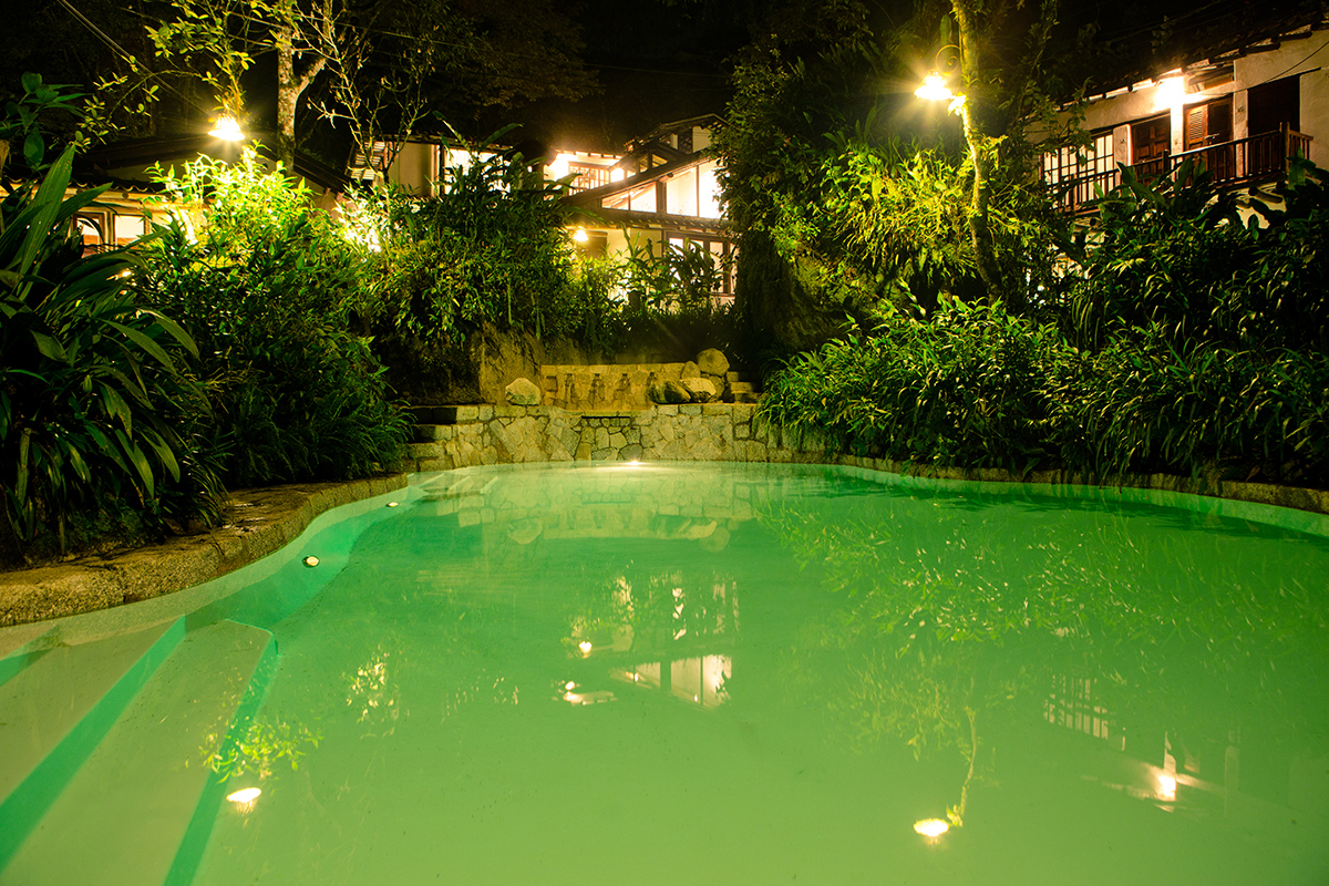 Inkaterra Machu Picchu Pueblo Hotel outdoor pool illuminated at night