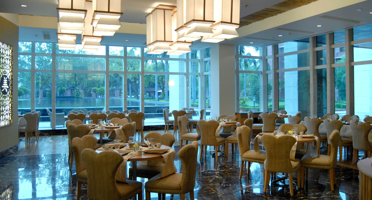 Jaypee Palace interior dining area overlooking the outdoor pool and patio