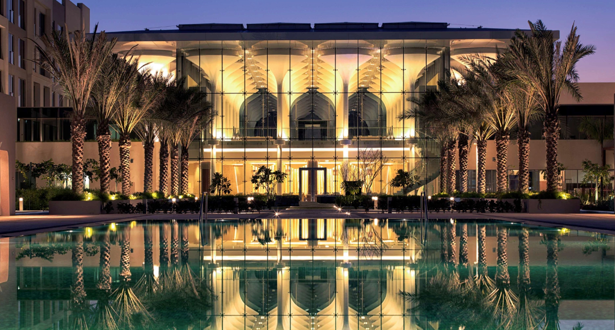 Kempinski Hotel Muscat courtyard and pool at dusk