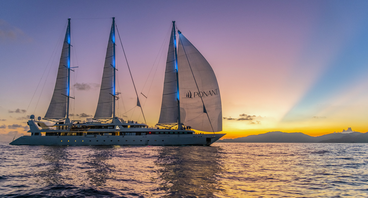 Le Ponant sailing at sunset