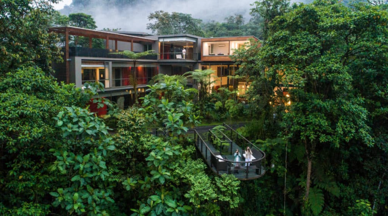 Mashpi Lodge exterior illuminated at dusk