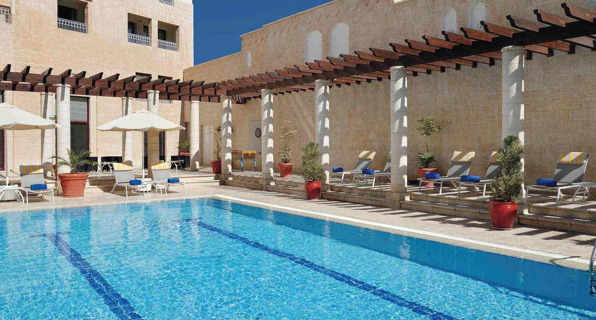 Mövenpick Resort Petra outdoor pool and chaise lounge seating