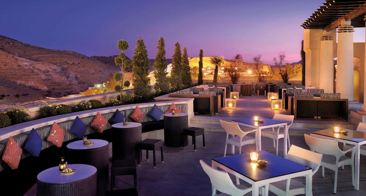 Mövenpick Resort Petra rooftop dining area illuminated in the evening