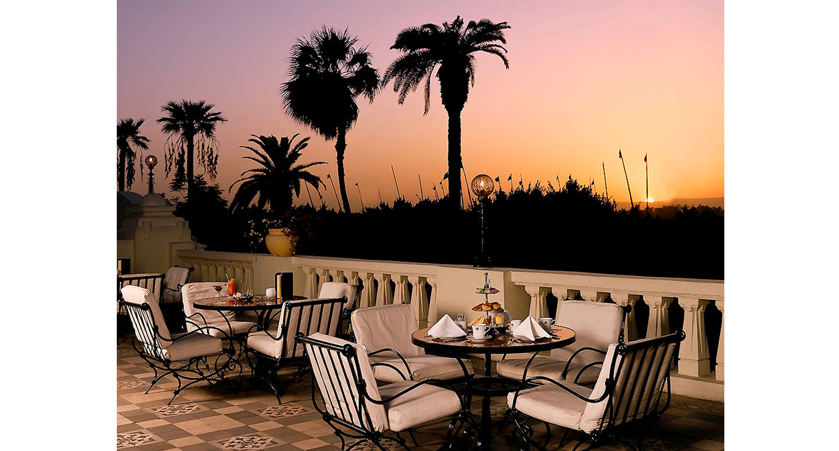 Winter Palace Hotel outdoor patio seating at dusk