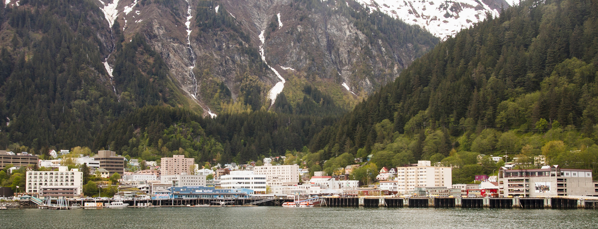Juneau, Alaska from the sea featuring snowcapped mountains in the background