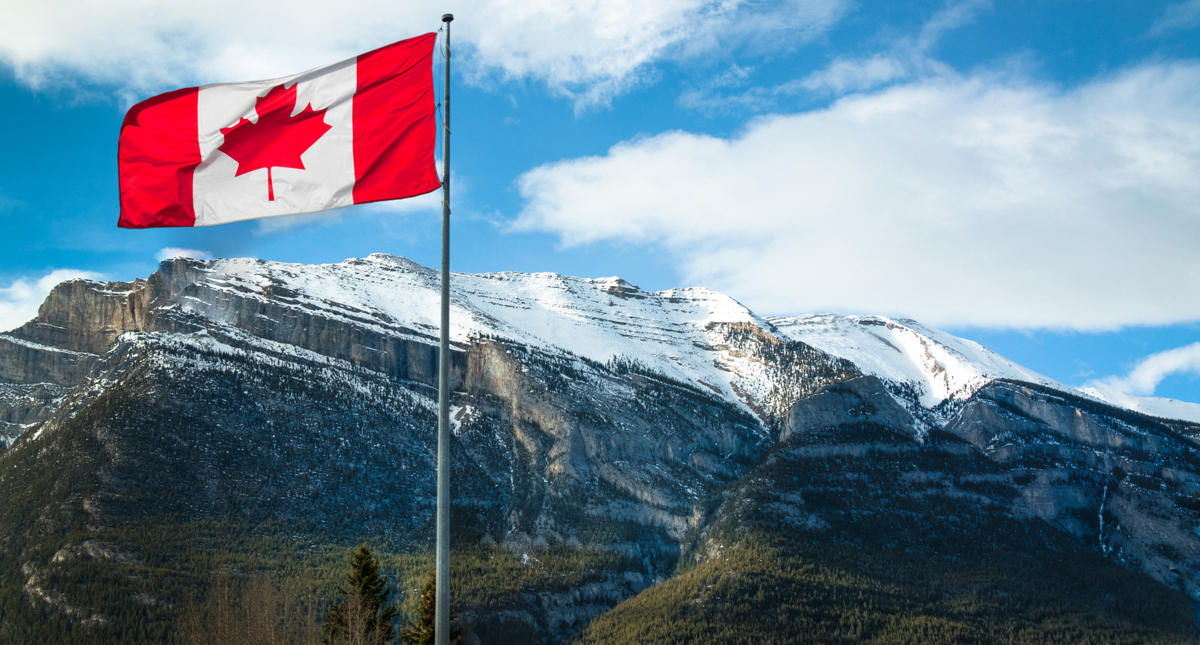 Canadian flag flying over the Rockies