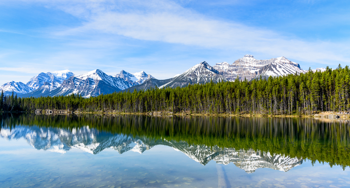 Rocky mountain peaks over Herbert Lake in Banff National Park