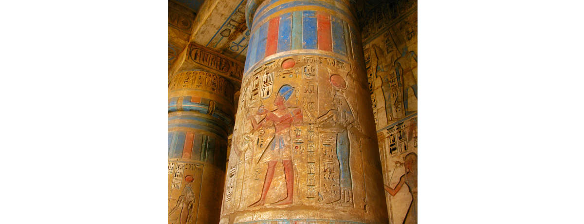 Colorful Egyptian carvings on tall pillars