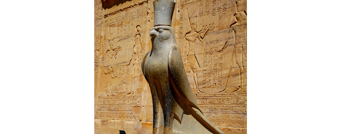 Hieroglyphs and statue outside of Horus Temple located near Edfu, Egypt