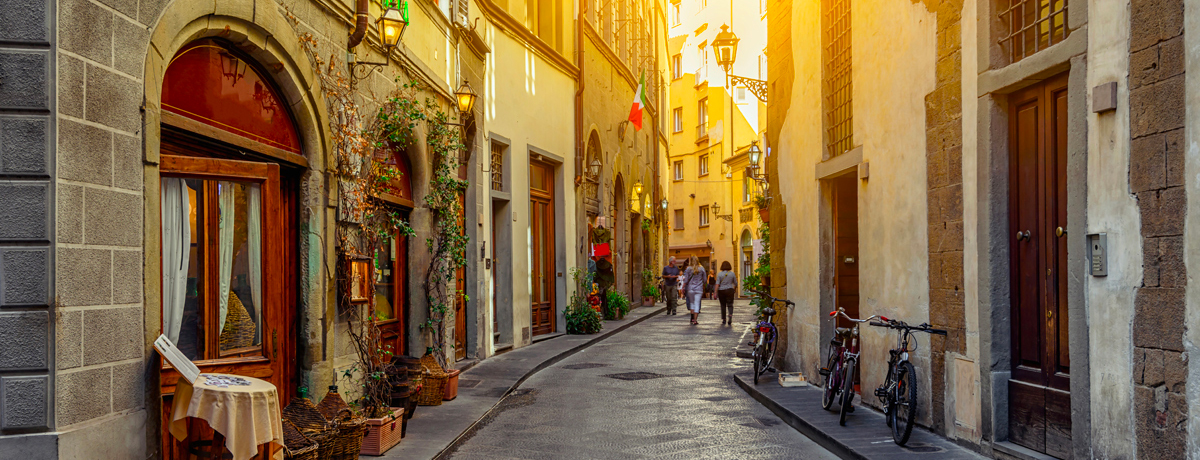 Charming side street in Florence, Italy with sun setting in background