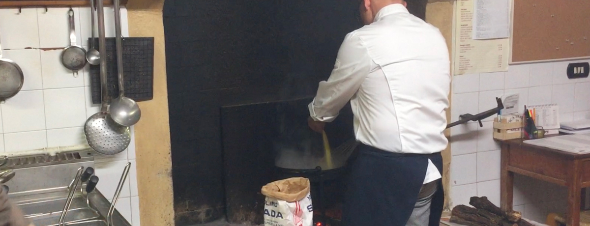 Chef explaining how to make fresh polenta over an open fire