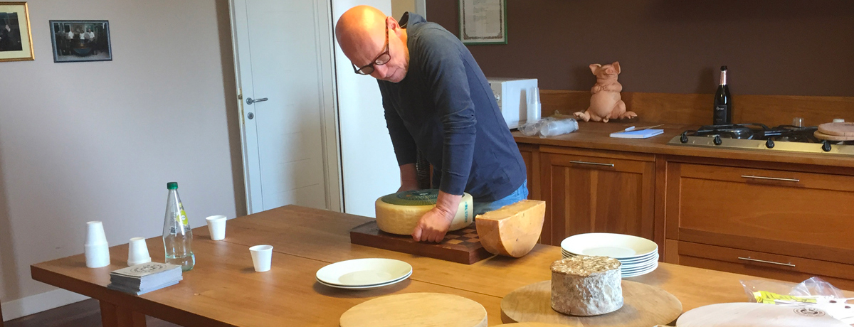 Propriety of La Casara slicing and introducing cheeses during a special tasting