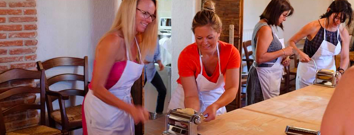 Guests using pasta makers during cooking class