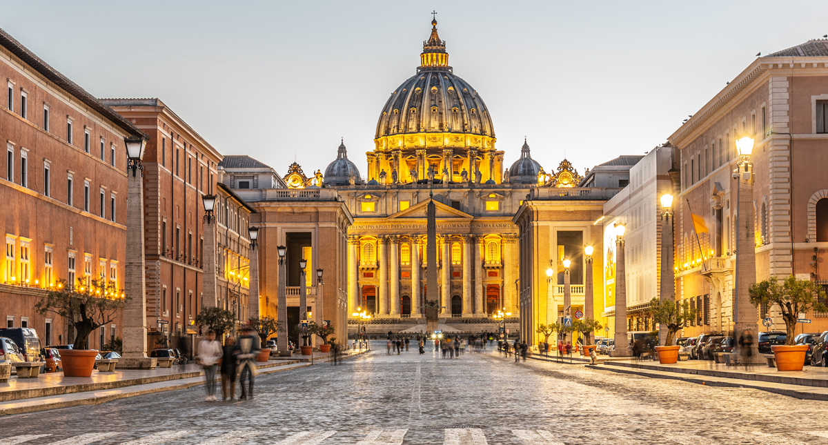 Illuminated dome of St. Peter's Basilica and St. Peters Square in Rome