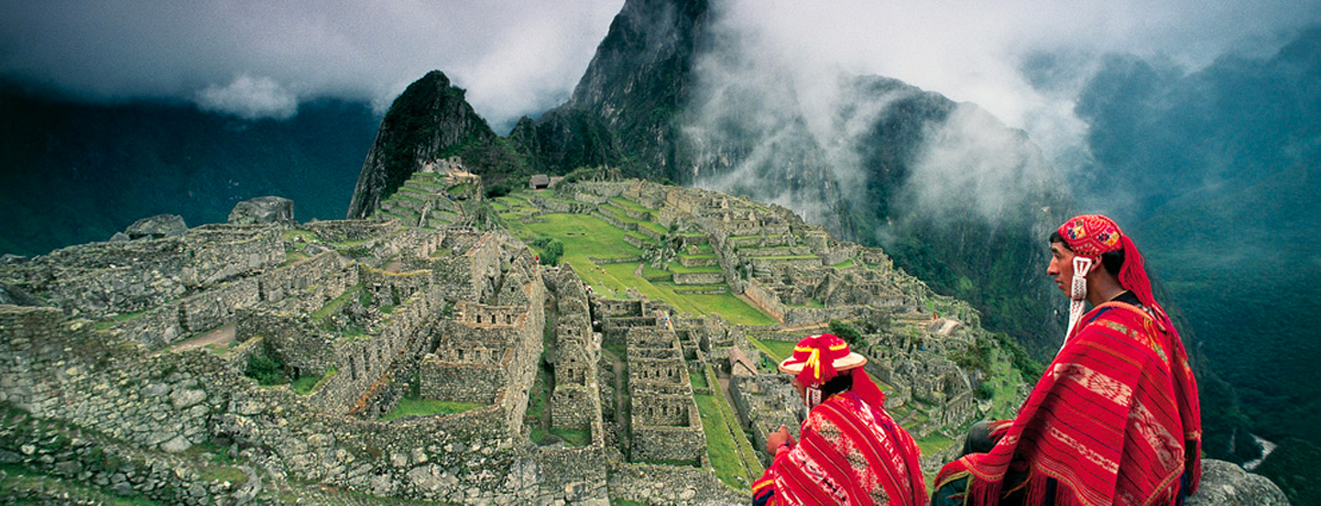 Two Peruvian men overlooking Machu Picchu