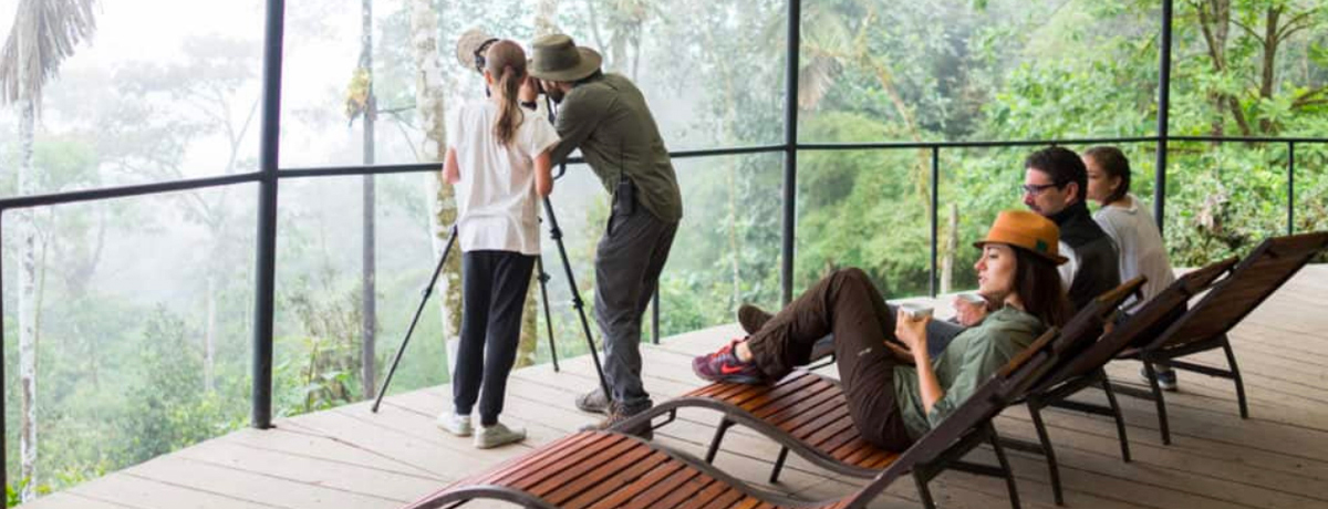 Guests at the life center viewing the forest through telescope