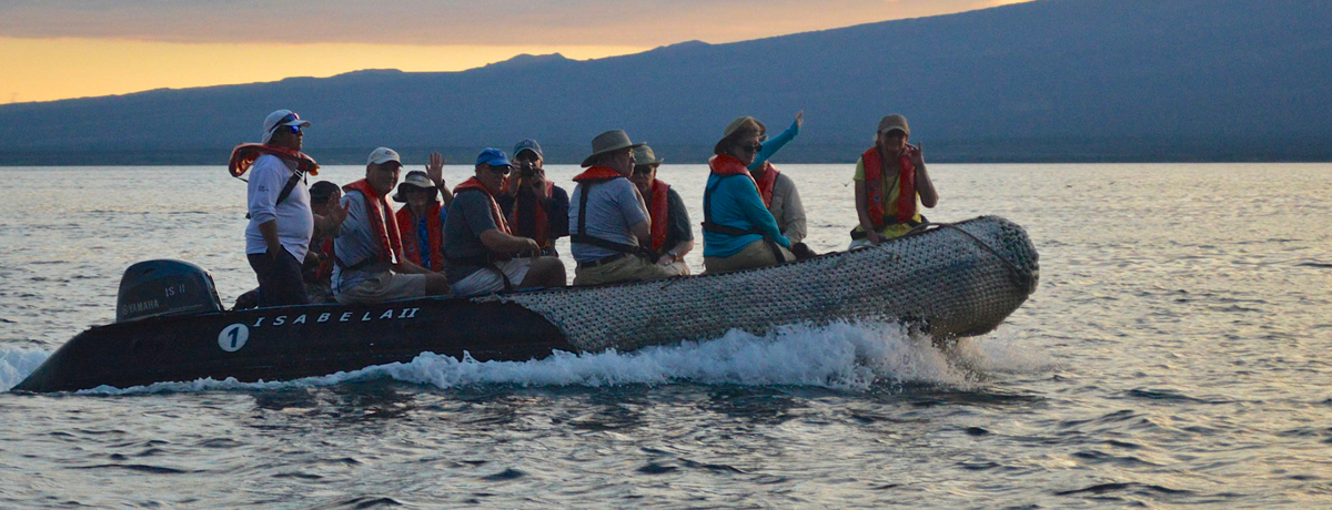 Guests riding on a skiff during sunset