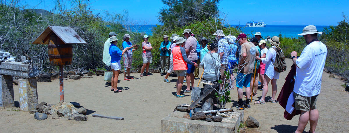 Guests gathered around the Galapagos post office barrel