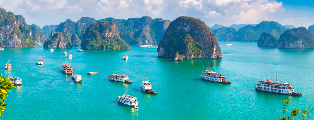 Halong Bay with small ships in the bright waters
