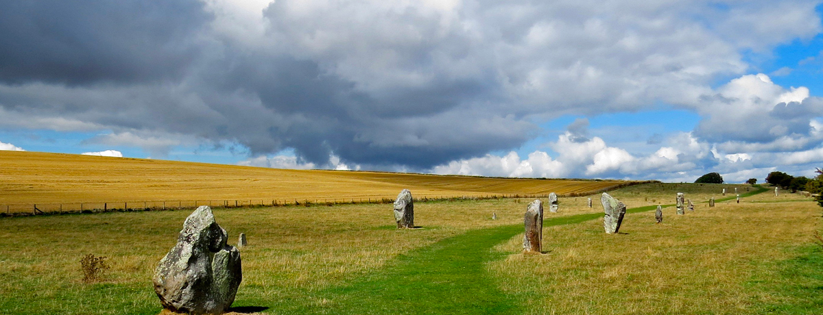 Avebury stone structures under a cloudy sky