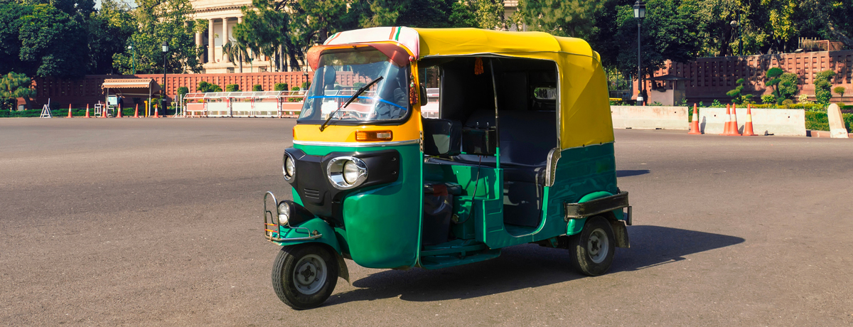 A traditional Indian tuk tuk rickshaw taxi on a street in New Delhi