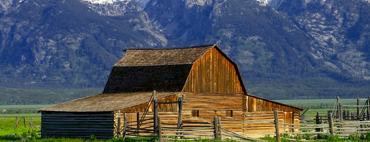 Wood barn with snowy mountains in the background