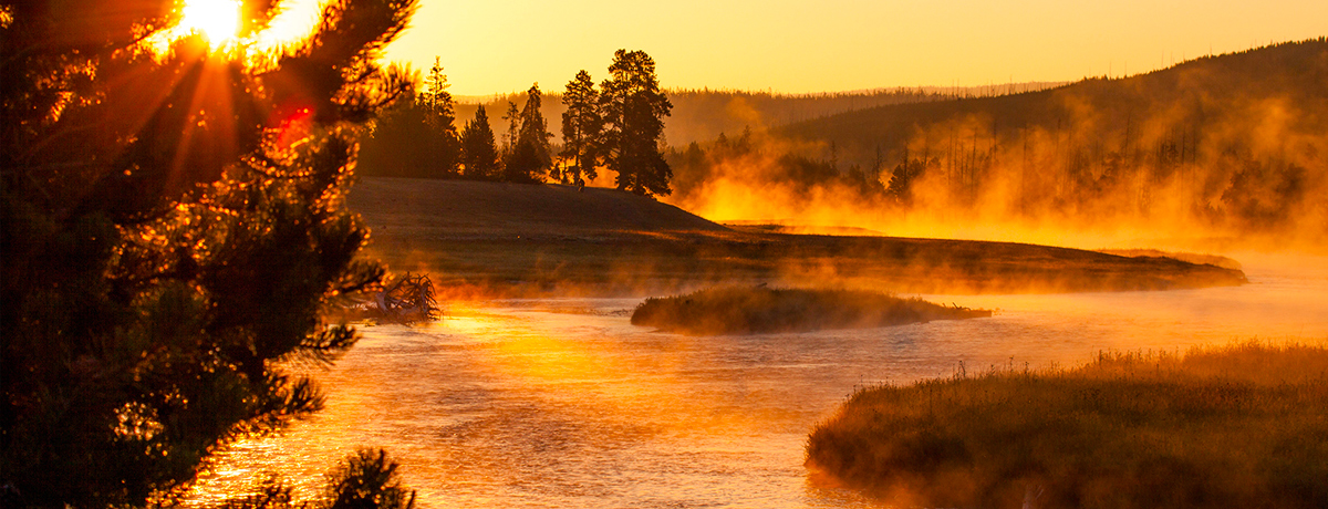 Steam rising from a river during sunrise