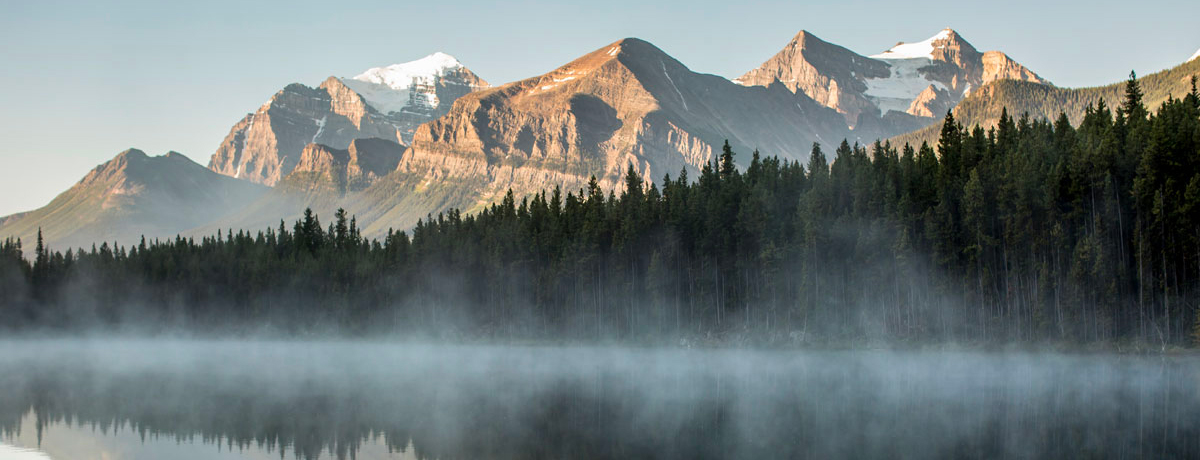 Calm lake with steam rising at Banff National Park