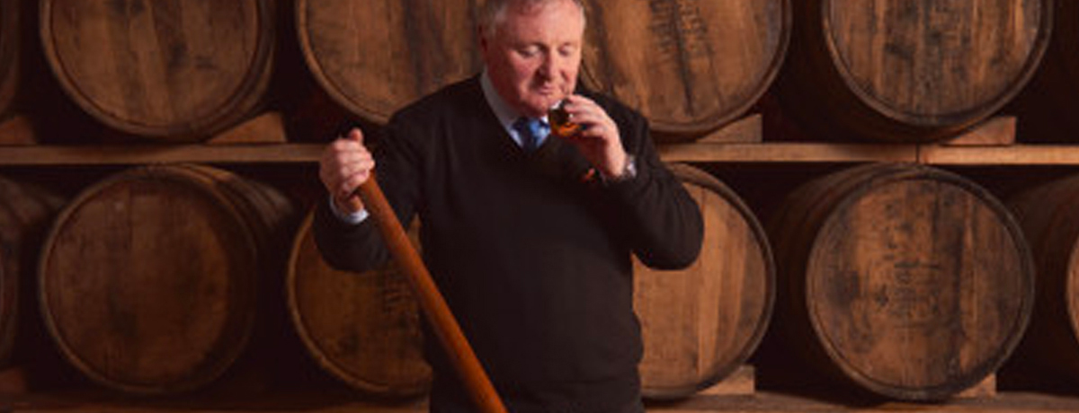 Whisky maker tasting from a barrel