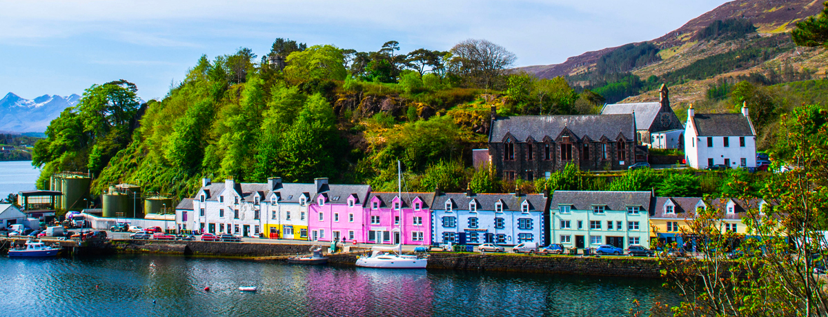 Scenic landscape view of colorful buildings and houses in the harbor of Portree on the Isle Of Skye