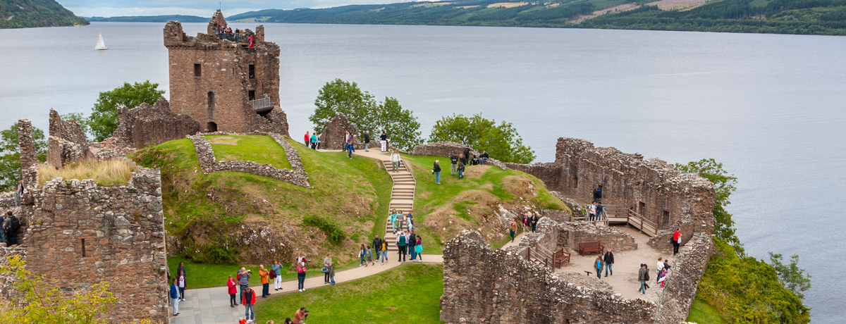 Guests strolling around Urquhart Castle beside Loch Ness