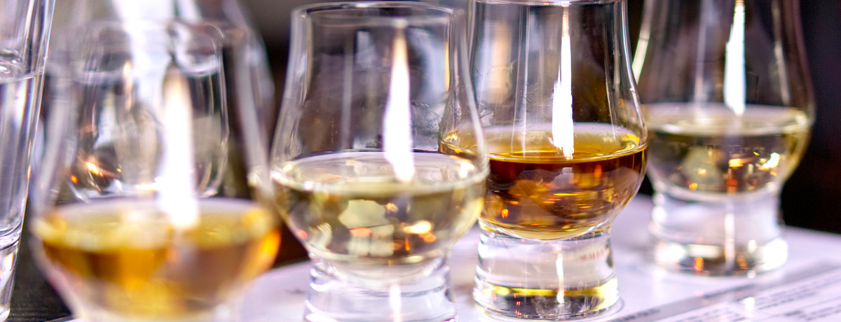 Close-up of four different whiskies in whisky tasting glasses