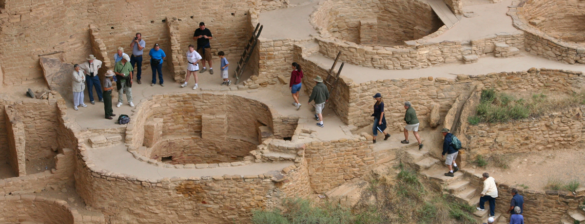 Visitors exploring stone dwellings at Mesa Verde