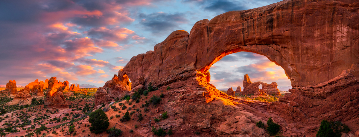Evening light over North Window with Turret Arch in the distance at Arches National Park