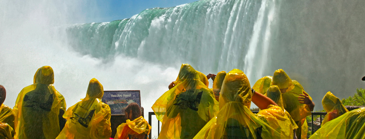 Guests in rain suits photographing Niagara Falls up-close