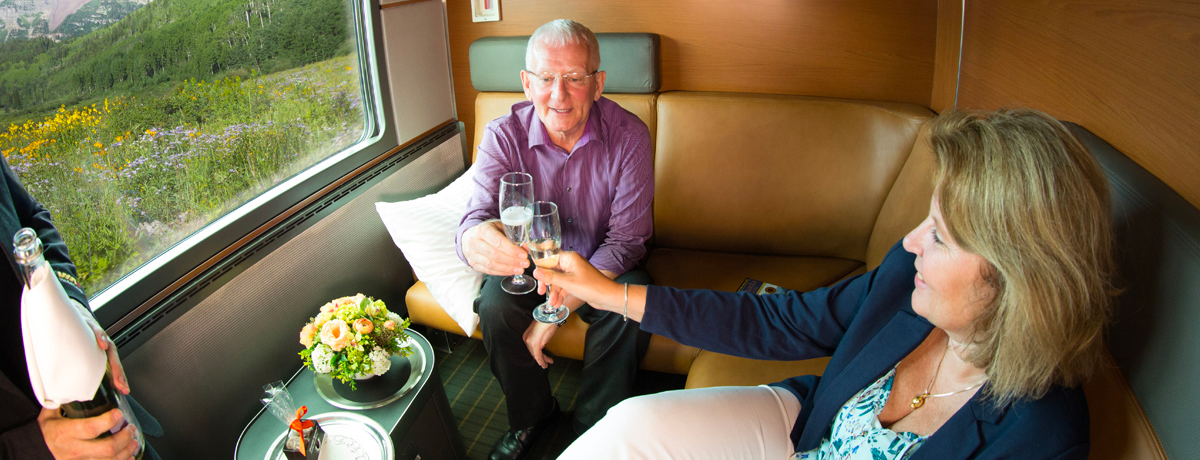 Guests enjoying a beverage in their Prestige Class stateroom during embarkation