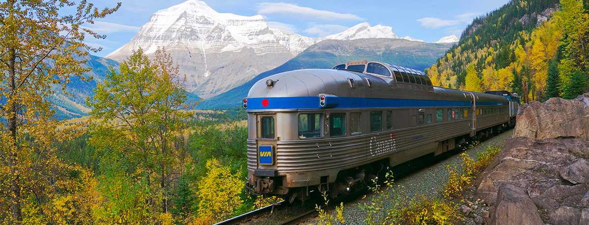 Train on a railroad track in the mountains of Canada.