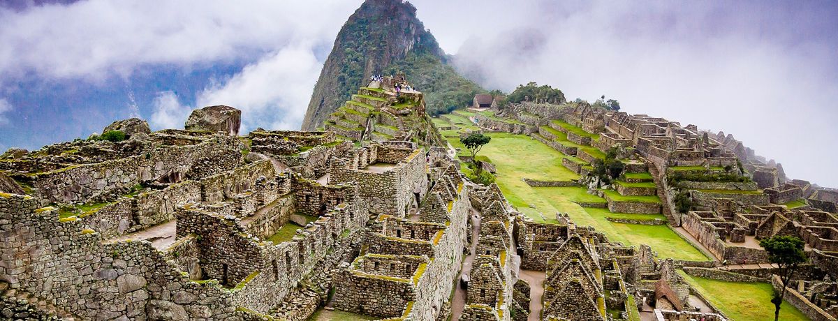 Sun rays and wispy clouds over Machu Picchu