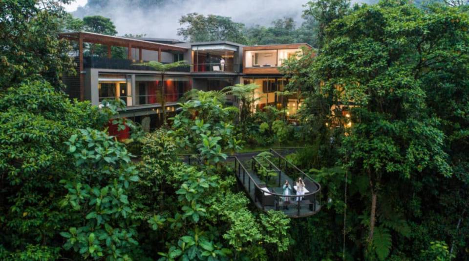 Mashpi Lodge exterior illuminated at dusk