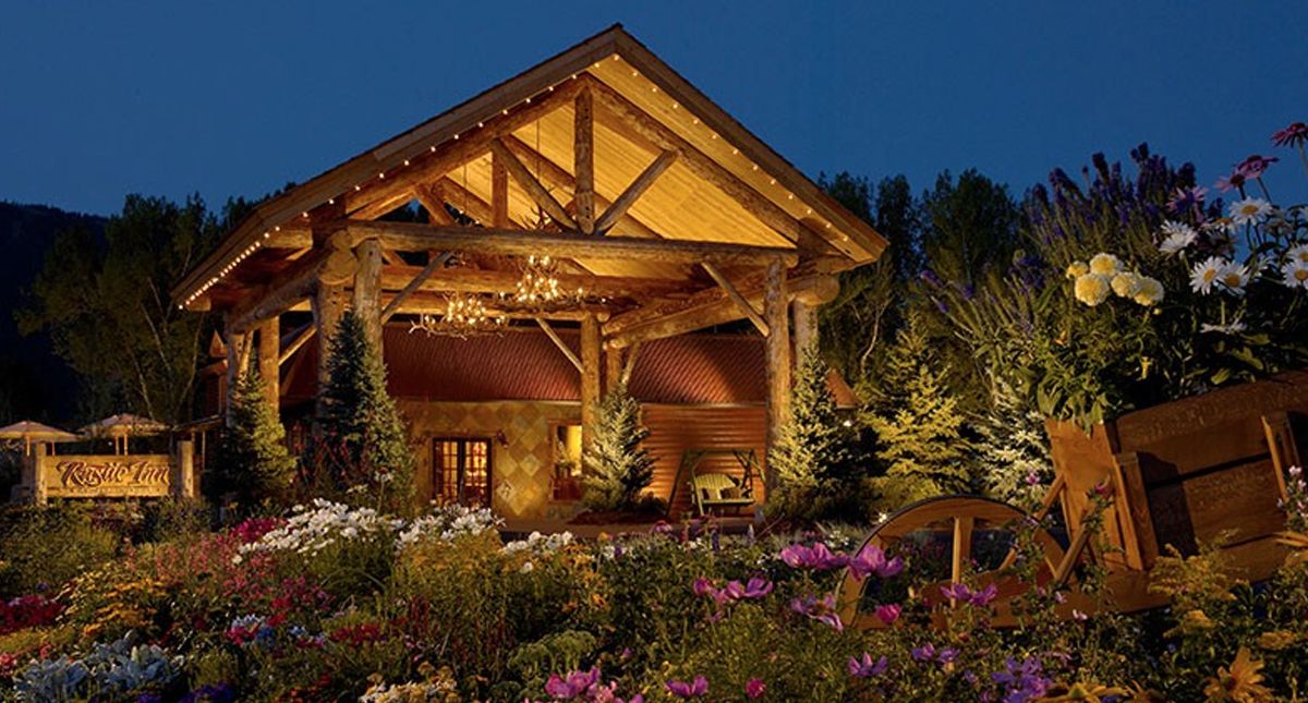 Rustic Inn at Jackson Hole Creekside Resort and Spa exterior and entrance illuminated at night