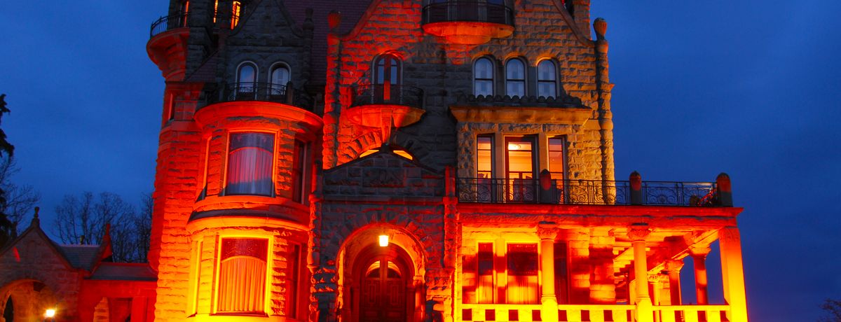 Historic Craigdarroch Castle illuminated at night in downtown Victoria